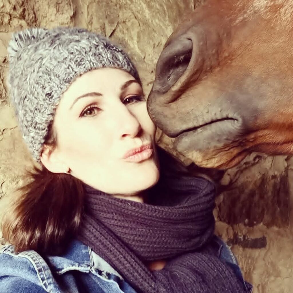 Christel Fischer profile picture of horse kissing on cheeck